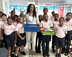 MP Romou and her adopted grade 3 class at Sister Marie Laurence Primary school with the donated Books